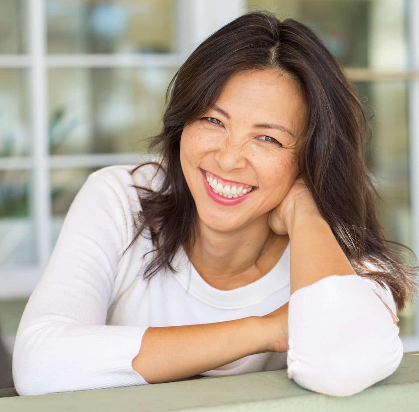Portrait of an Asian woman smiling.