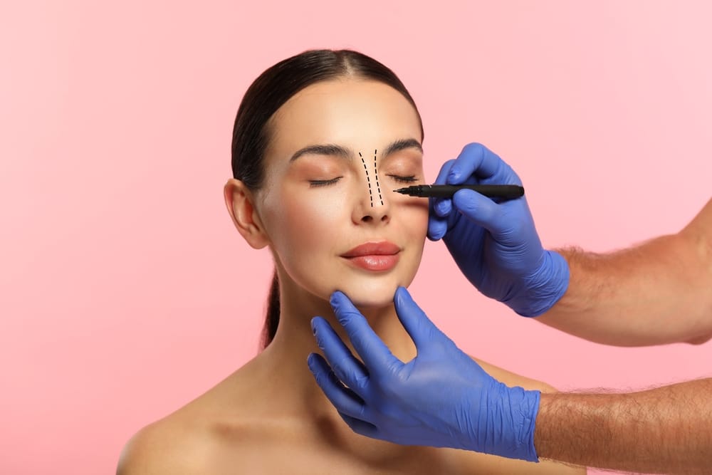 Woman being marked on by surgeon to prepare for rhinoplasty in Salt Lake City, UT