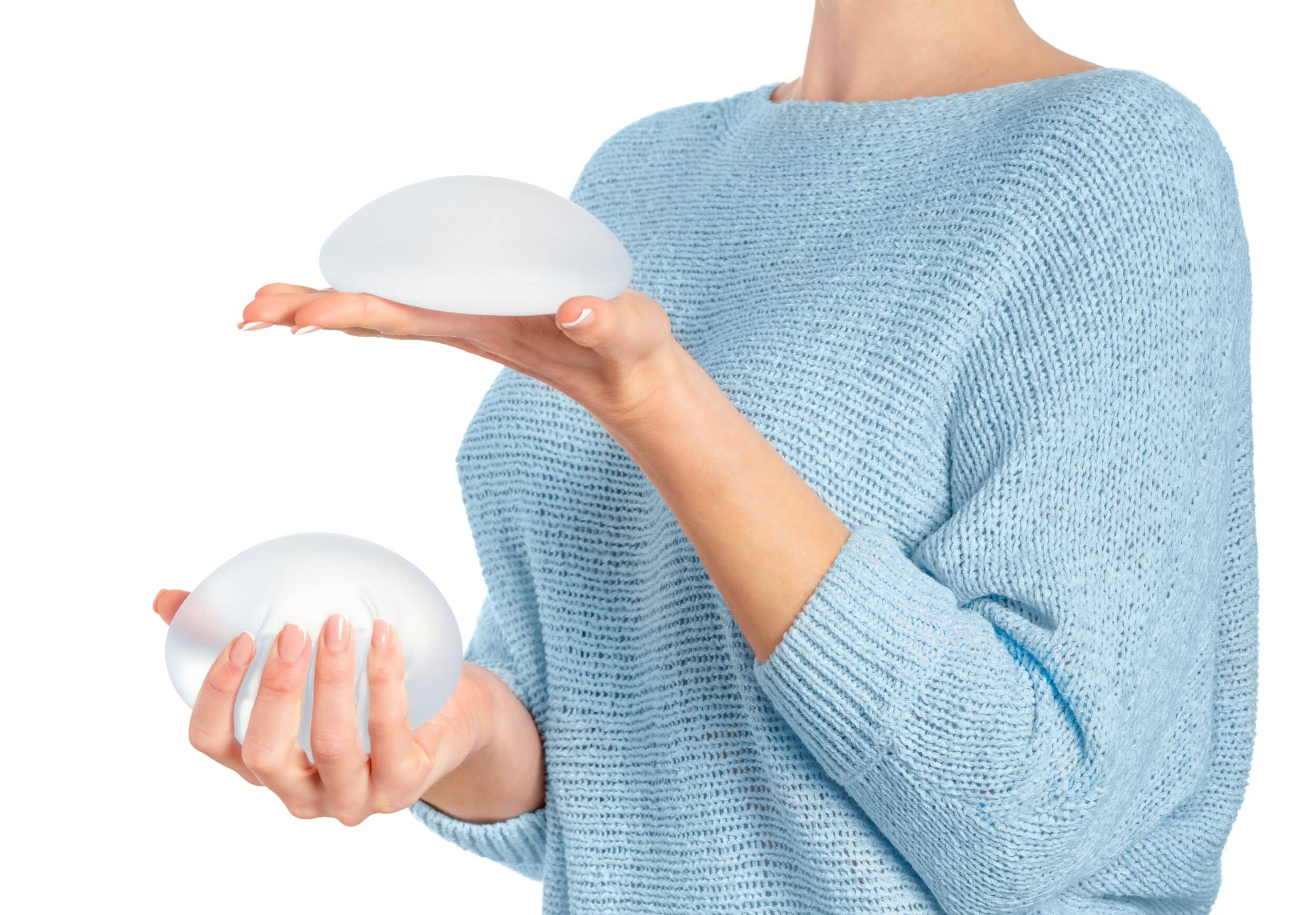 Woman holding breast implants, deciding which is right for her in Salt Lake City